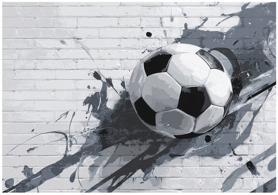 Fotobehang met een close-up van een voetbal op een grijze bakstenen muur, met zwarte en grijze verfspatten.