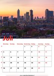 Kalenderpagina Juli met stadspanorama van Rotterdam bij zonsondergang.