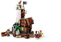 Fort LEGO pirate avec tour, bâtiment en bois, canon et palmier vert.