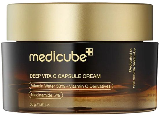 Pot de crème Medicube Deep Vita C Capsule avec un couvercle doré et un corps brun, arborant les inscriptions 'Vitamin Water 50% + Vitamin C Derivatives' et 'Niacinamide 5%'.