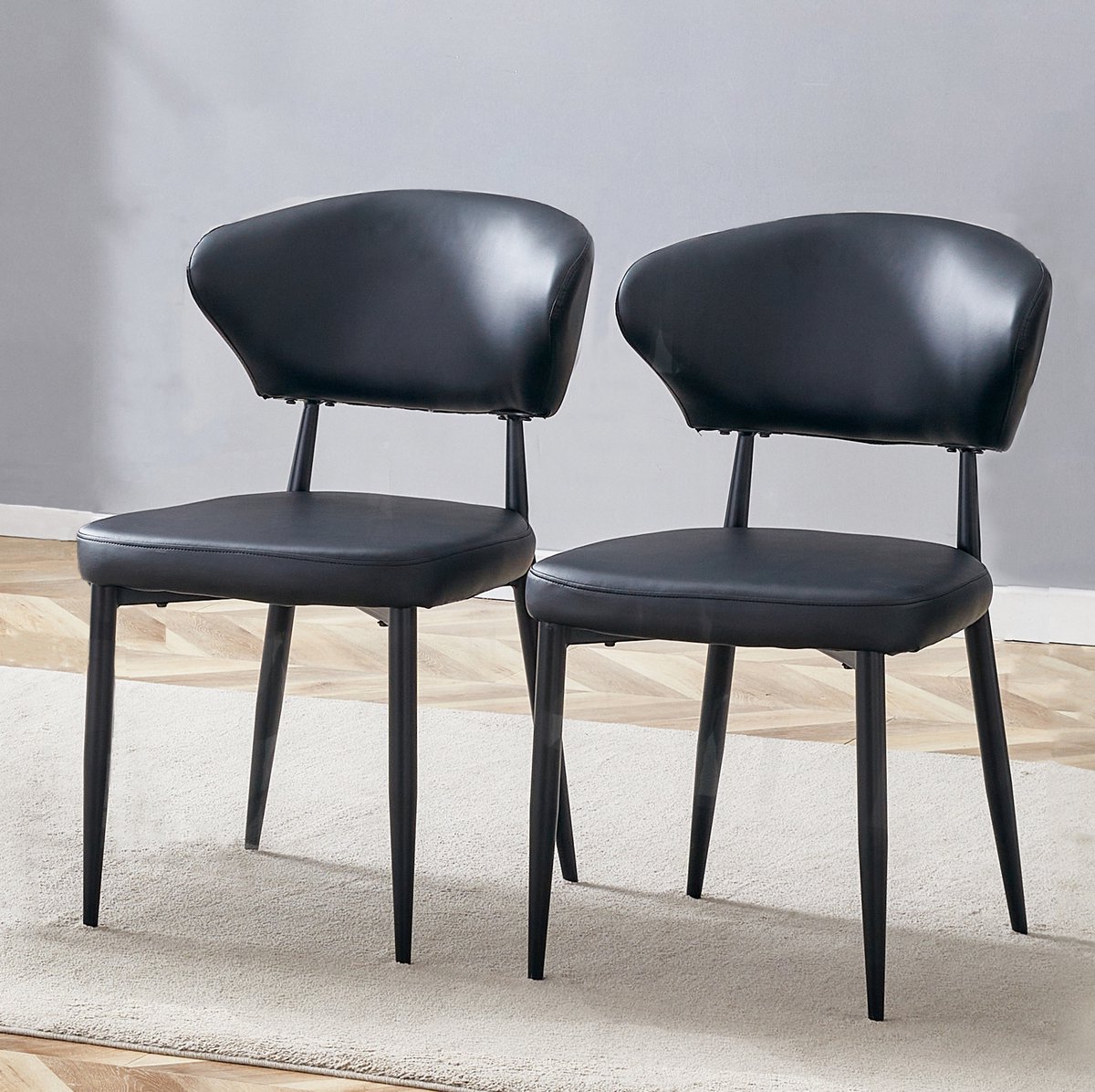 MEUNIQ zwarte eetkamerstoelen set van 2 met gebogen ergonomische rugleuning, zwart kunstleer, metalen poten en modern design voor eetkamer