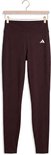 Bruine Adidas legging met witte streepjeslogo op de linkerheup.
