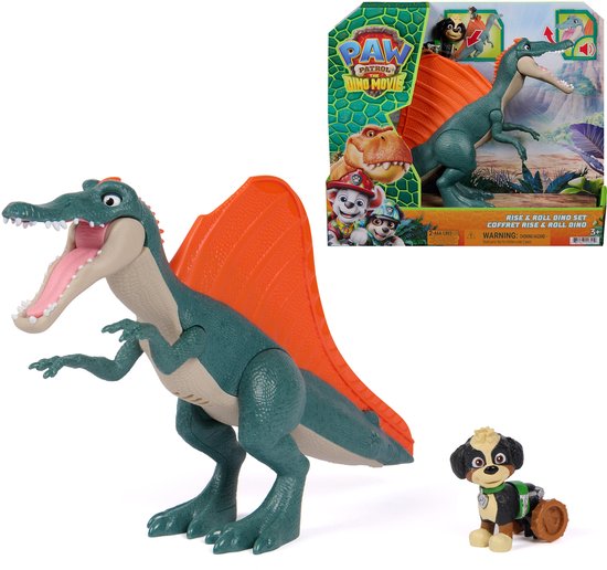 Un dinosaure Spinosaurus vert avec une voile dorsale orange et un petit chien. L'emballage est visible à l'arrière. 'RISE & ROLL DINO SET' est écrit sur l'emballage.