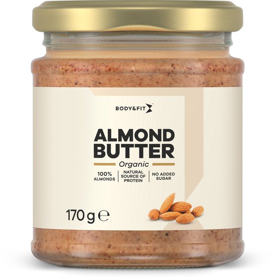 Pot en verre de beurre d'amande biologique Body & Fit avec couvercle doré. Étiquette avec "ALMOND BUTTER ORGANIC 100% ALMONDS" et "170 ge".