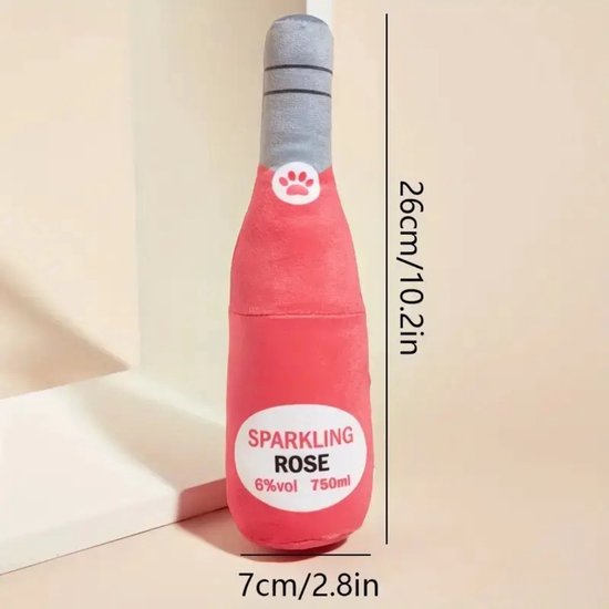 Peluche rose en forme de bouteille avec étiquette "SPARKLING ROSE 6%vol 750ml". Dimensions 26x7cm.