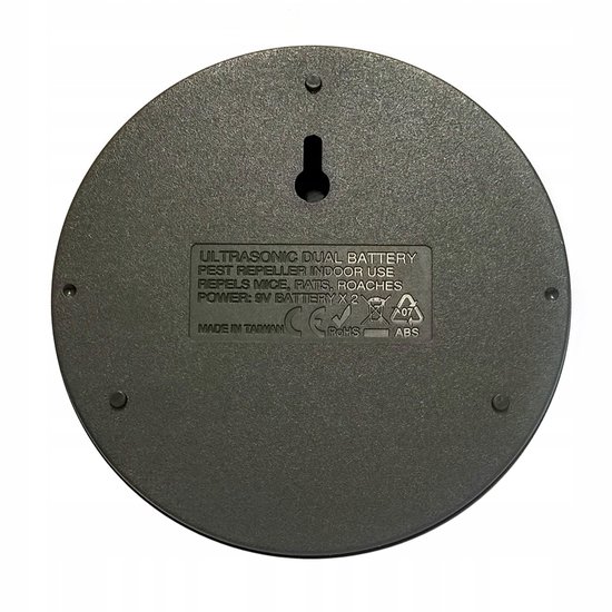 Grijze, ronde ultrasone ongedierteverjager voor binnengebruik, geschikt voor 2 x 9V batterijen. Tekst: Ultrasonische Dual Battery Pest Repeller Indoor Use.