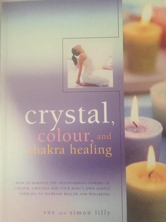 Boek met de titel 'crystal, colour, and chakra healing' in paarse letters, met een foto van een vrouw liggend in een ontspannen positie.
