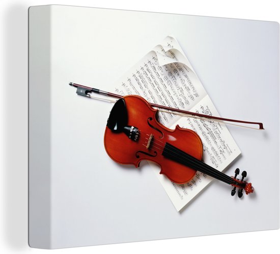 Canvas Schilderij Een viool met een strijkstok op bladmuziek - 40x30 cm - Wanddecoratie
