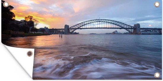 Tuinposter Uitzicht over het water bij de Sydney Harbour Bridge in Australië - 60x30 cm - Tuindoek - Buitenposter
