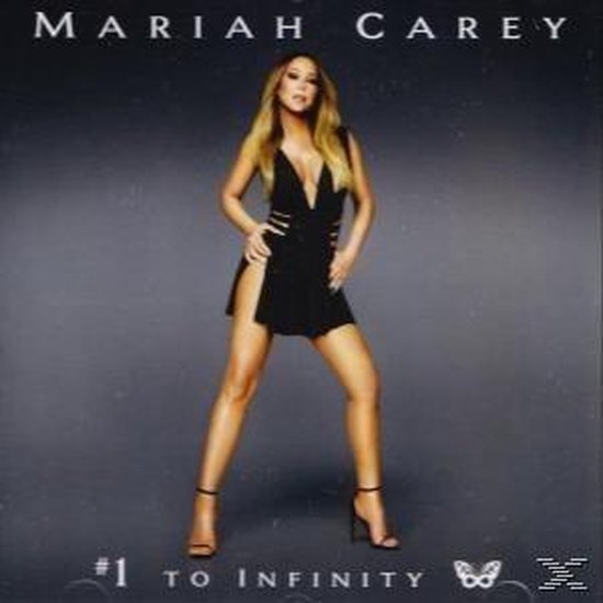 Mariah Carey draagt een zwarte jurk met diepe V-hals en hoge split, met #1 TO INFINITY geschreven aan de onderkant.