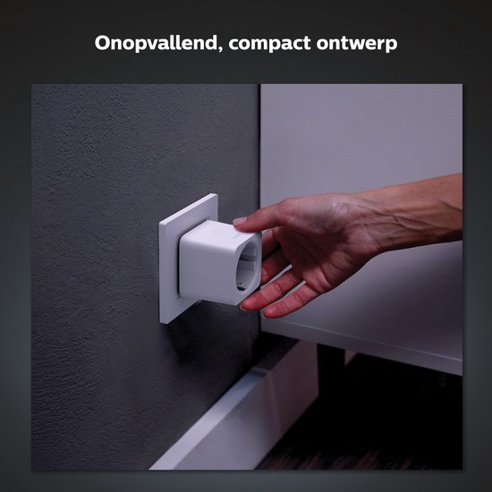 Hand steekt een witte Philips Hue slimme stekker in een stopcontact.