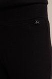 Zwarte legging met een klein wit sterlogo op de achterkant.