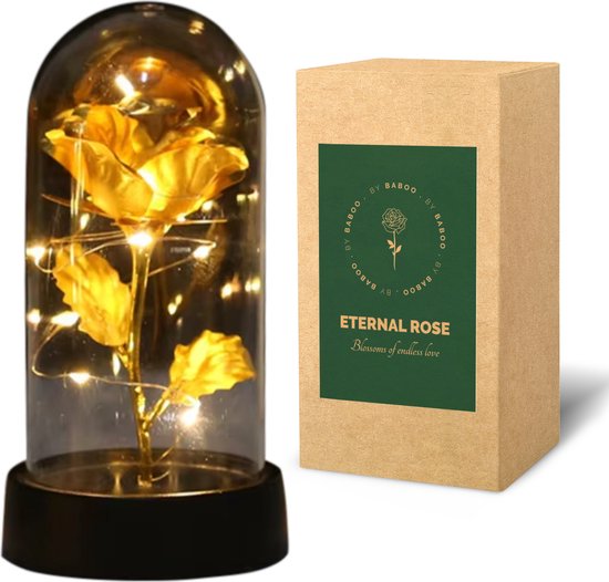 Gouden roos in stolp met LED-verlichting, naast een kartonnen geschenkdoos.