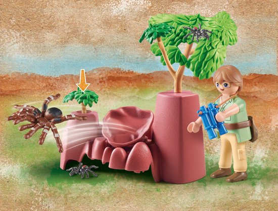Playmobil figuur met blauwe verrekijker, bruine spinnen en roze rotsen.
