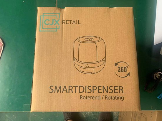 Bruine kartonnen doos met de tekst 'SMARTDISPENSER Roterend / Rotating' en een afbeelding van de dispenser.