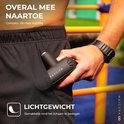 Hand stopt zwarte Maicura massagegun in zak van zwarte sportbroek. Lichtgewicht.