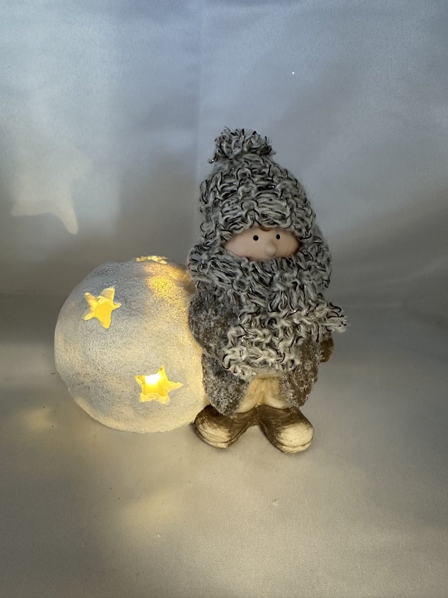 Kerstbeeldje jongen met sneeuwbal + sterren en LED - taupe + wit + glitters & gebreide muts/sjaal - polyresin - 13 cm hoog x 15 cm x 11 cm – Kerstdecoratie