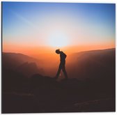 WallClassics - Dibond - Silhouet Persoon tussen de Bergen bij Zonsondergang - 50x50 cm Foto op Aluminium (Met Ophangsysteem)