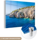 MuchoWow® Glasschilderij 120x80 cm - Schilderij acrylglas - Grotten aan de kust - Foto op glas - Schilderijen