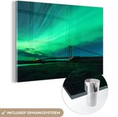 MuchoWow® Glasschilderij 150x100 cm - Schilderij acrylglas - Noorderlicht - Brug - IJsland - Foto op glas - Schilderijen