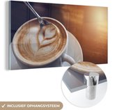 MuchoWow® Glasschilderij 120x60 cm - Schilderij acrylglas - Een lepel roert door de schuimlaag van een bakje koffie - Foto op glas - Schilderijen