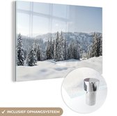 MuchoWow® Glasschilderij 120x80 cm - Schilderij acrylglas - Winterlandschap met dennenbomen - Foto op glas - Schilderijen