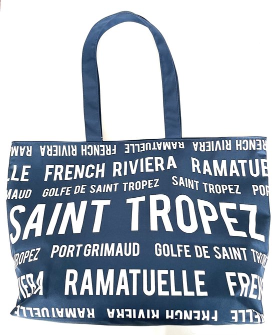 Donkerblauwe tas met witte tekst: "SAINT TROPEZ" en andere Franse plaatsnamen.