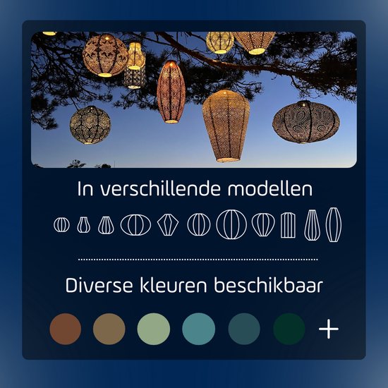 Diverse modellen en kleuren lampionnen hangend in een boom bij schemering.