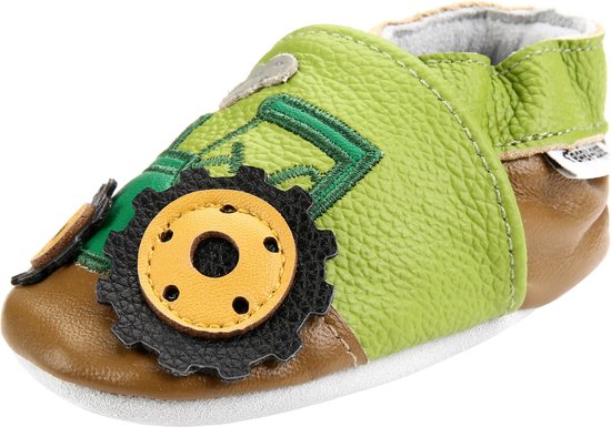 Zijzicht van een groen babyslofje met bruine zool en tractorprint. Zwarte en gele wielen.