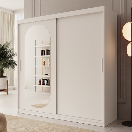 Witte kledingkast met ovale spiegeldeur, naast een plant in een moderne kamer.