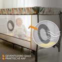 Donkergrijs reisbedje met baby, gestreepte trui, met geometrische print langs de bovenrand.
