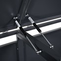Detail van de gasveren voor de deksels van een grijze containerberging.
