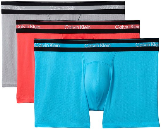 Drie Calvin Klein boxers: turquoise, roze en grijs, met zwarte banden.