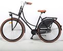 Zwarte dames transportfiets met bruine zitting en banden.