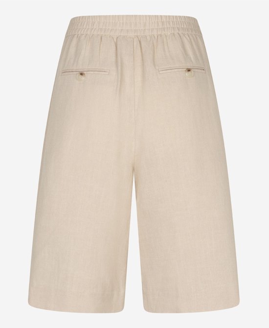 Achterkant van een beige culotte met elastische taille en twee knopen op de achterzakken.