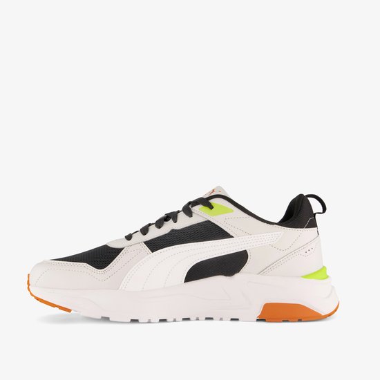 Witte leren sneaker met zwarte mesh, witte Puma-streep, oranje zool en felgroene accenten.