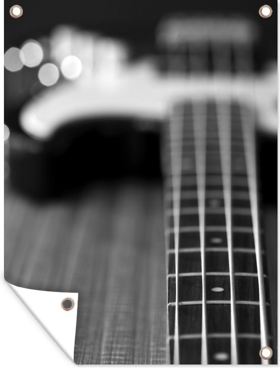 Décoration de Jardin Une guitare basse repose sur le sol - noir et blanc - 30x40 cm