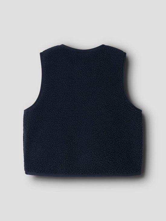 Achterkant van het marineblauwe teddy gilet met een zachte, pluizige textuur.