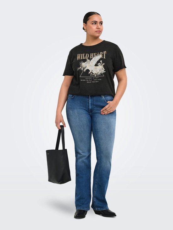 Model draagt een donkergrijs t-shirt met de tekst 'WILD HEART' en een adelaarprint met bloemen, gecombineerd met een blauwe jeans.