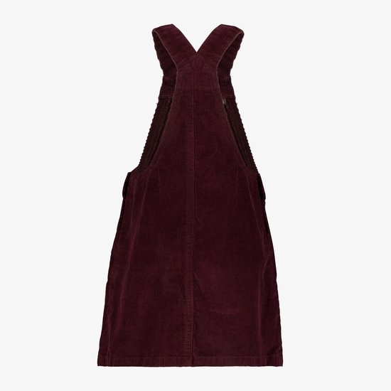 Achterkant van een bordeauxrode corduroy tuinbroekjurk met gekruiste bandjes.