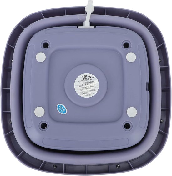 Bas du mini-lave-linge pliable violet avec pieds en caoutchouc et une étiquette d'avertissement.
