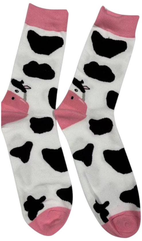 Witte sokken met zwarte koeienvlekken, roze boord en roze neus en oren van een koe.