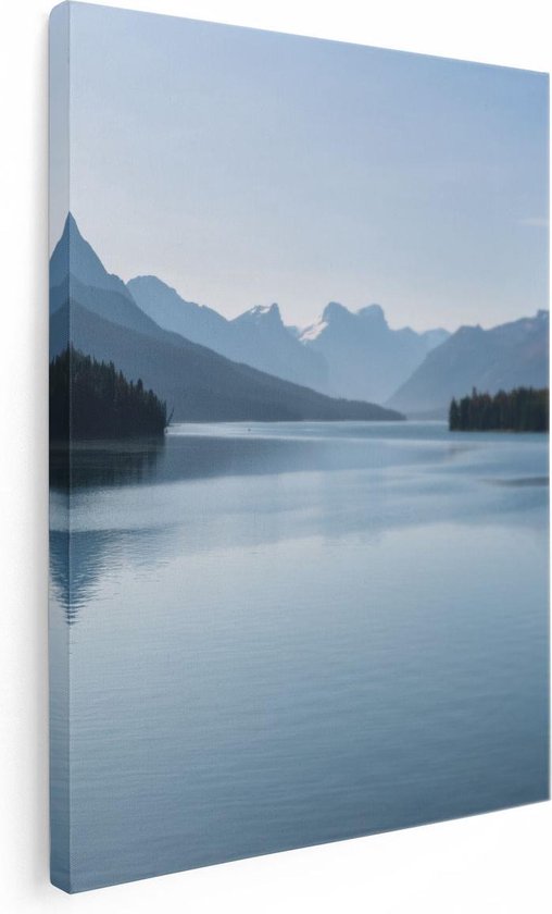 Canvas schilderij van een bergachtig landschap met een rustig meer en bomen, weergegeven op een witte achtergrond.