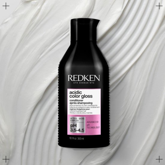 Conditionneur Redken Acidic Color Gloss. Flacon noir avec texte rose et blanc. pH 3.5-4.5.