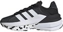 Baskets noires pour femme avec bandes blanches Adidas, accents blancs et taches noires sur la semelle.