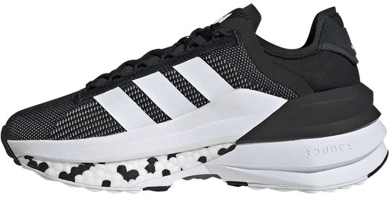 Baskets noires pour femme avec bandes blanches Adidas, accents blancs et taches noires sur la semelle.