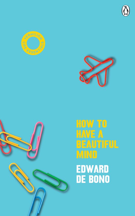 Boek 'How to Have a Beautiful Mind' met rode paperclip in de vorm van een vliegtuig, gele en roze paperclips, en een gele cirkel op een turquoise achtergrond.