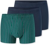 Drie herenboxershorts, twee effen donkerblauw en één met verticale strepen in groen, wit en grijs.