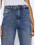 Close-up van de tailleband en zakken van een blauwe stonewashed jeans.