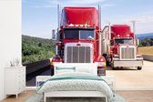 Behang - Fotobehang Rode vrachtwagens op de snelweg - Breedte 330 cm x hoogte 220 cm